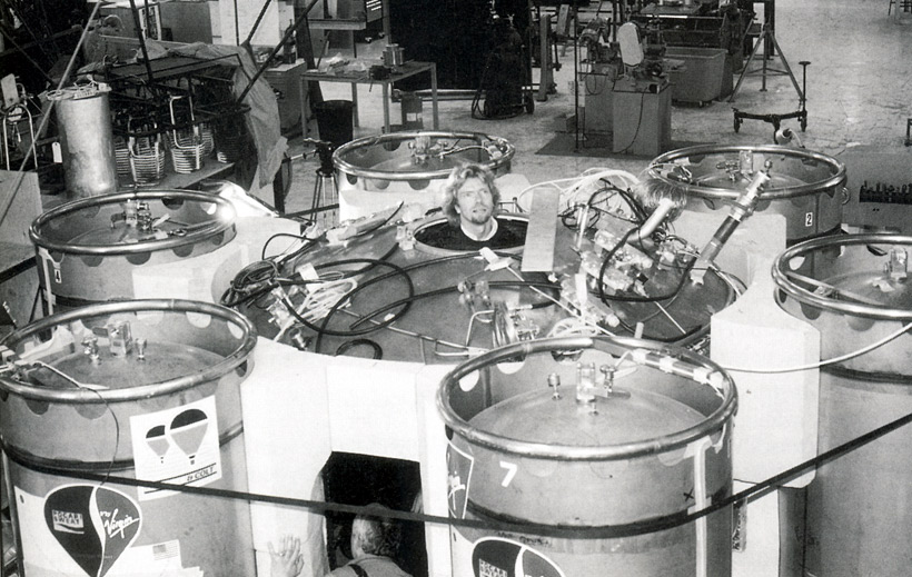 Picture of Richard Branson looking out over six fuel tanks