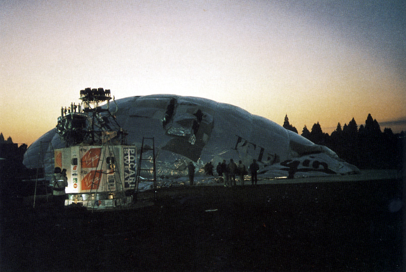 Picture of the deflating balloon is silhouetted against the rising sun